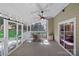 Covered porch includes a ceiling fan, dining table, and sliding doors at 807 Water Wheel Ct, Charlotte, NC 28209
