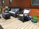 Brick home exterior showing a backyard deck with patio furniture at 814 Aileen Cir, Pineville, NC 28134