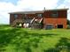 Exterior brick home showing a backyard with a deck and green grass at 814 Aileen Cir, Pineville, NC 28134