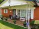 Cozy front porch with seating, decorative plants, and a secure front door at 814 Aileen Cir, Pineville, NC 28134