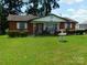Charming single-story brick home with a well-maintained lawn and inviting front porch at 814 Aileen Cir, Pineville, NC 28134