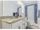 Bathroom featuring double sinks with granite countertops, white cabinets, and a shower-tub combination at 9547 Horsebit Ln, Concord, NC 28027