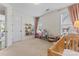 Cozy bedroom with neutral carpet, a window with blinds, and a play area at 9547 Horsebit Ln, Concord, NC 28027