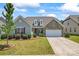 Charming single-Gathering home featuring a manicured lawn, stone accents, and an attached two-car garage at 9547 Horsebit Ln, Concord, NC 28027