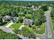 Stunning aerial view of a beautiful home with a manicured lawn and mature trees in a quiet neighborhood at 9800 Ashley Farm Dr, Matthews, NC 28105