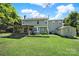A spacious backyard with a storage shed, wooden deck, and vibrant green lawn under a bright sky at 9800 Ashley Farm Dr, Matthews, NC 28105