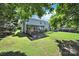 Expansive backyard featuring a deck, well-maintained lawn, and mature trees for privacy at 9800 Ashley Farm Dr, Matthews, NC 28105