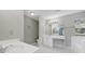Bright bathroom featuring dual sinks, a vanity area, and natural light at 9800 Ashley Farm Dr, Matthews, NC 28105