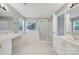 Large bathroom with a bathtub, stand up shower, double sinks and bright, natural lighting at 9800 Ashley Farm Dr, Matthews, NC 28105