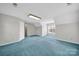 Spacious bedroom with plush blue carpeting and natural light at 9800 Ashley Farm Dr, Matthews, NC 28105