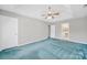 Large bedroom featuring plush carpeting, natural light, and an en suite bathroom at 9800 Ashley Farm Dr, Matthews, NC 28105
