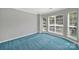 Bedroom featuring neutral paint, plush carpet, and multiple windows at 9800 Ashley Farm Dr, Matthews, NC 28105