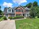 Beautiful two-story home with brick facade, black shutters, and a well-maintained front lawn at 9800 Ashley Farm Dr, Matthews, NC 28105