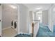 Upstairs hallway with hallway view featuring the laundry area with modern machines and neutral colors at 9800 Ashley Farm Dr, Matthews, NC 28105