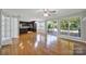 Open living space connecting kitchen and hardwood floors, and natural light at 9800 Ashley Farm Dr, Matthews, NC 28105
