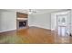 Bright living room with a brick fireplace, hardwood floors, and access to a hallway at 9800 Ashley Farm Dr, Matthews, NC 28105