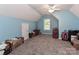 Finished attic space with carpet flooring, a window, and plenty of room for storage at 103 Pamlico Ln, Mooresville, NC 28117