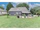 A backyard with a back patio, awning, and lush lawn, providing an ideal outdoor living space at 103 Pamlico Ln, Mooresville, NC 28117