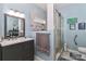 Stylish bathroom with a gray vanity, tiled shower with glass door, and modern fixtures at 103 Pamlico Ln, Mooresville, NC 28117