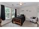 Cozy bedroom with natural light, a comfortable bed, and a plush accent chair at 103 Pamlico Ln, Mooresville, NC 28117