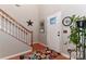 Inviting entryway with wood floors, white staircase and a charming Lake Norman compass rose decor at 103 Pamlico Ln, Mooresville, NC 28117
