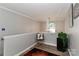 Cozy hallway with wood floors, an accent chair, and view of a window with natural light at 103 Pamlico Ln, Mooresville, NC 28117