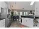 Bright open-concept kitchen and dining area showcasing modern design and stainless steel appliances at 103 Pamlico Ln, Mooresville, NC 28117