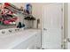 Functional laundry room with washer, dryer, and shelving for organized storage at 103 Pamlico Ln, Mooresville, NC 28117