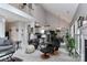 Bright living room with vaulted ceilings, a loft, and views of the modern kitchen and dining area at 103 Pamlico Ln, Mooresville, NC 28117