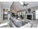 Spacious living room with vaulted ceiling, skylight, fireplace, and an open floor plan at 103 Pamlico Ln, Mooresville, NC 28117