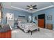 Comfortable main bedroom with a decorative ceiling fan, artwork, and ample natural light at 103 Pamlico Ln, Mooresville, NC 28117