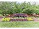 Inviting entrance to Harbor Cove with landscaped flower beds and mature trees at 103 Pamlico Ln, Mooresville, NC 28117