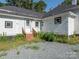 Backyard features a brick stairwell and a gravel area at 110 College St, Marshville, NC 28103
