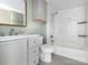 Modern bathroom with gray vanity, tiled shower-tub combo, and updated fixtures at 110 College St, Marshville, NC 28103