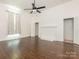 Large bedroom featuring wood floors, fireplace, ceiling fan, and access to multiple other rooms at 110 College St, Marshville, NC 28103