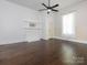 Bedroom featuring a decorative fireplace, wood floors, and natural light at 110 College St, Marshville, NC 28103