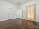 Room with hardwood floors, two large doors, beige curtains and chandelier lighting at 110 College St, Marshville, NC 28103