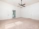 Spacious bedroom with carpet flooring, a ceiling fan, and access to an en-suite bathroom at 110 College St, Marshville, NC 28103