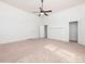 Bright bedroom with neutral carpet, fan, two closets, and natural light at 110 College St, Marshville, NC 28103