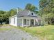 Traditional style home with front porch and American Flag in grassy yard at 110 College St, Marshville, NC 28103