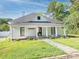 Charming, one-story home featuring a covered front porch, an American flag, and stone walkway amid a grassy yard at 110 College St, Marshville, NC 28103