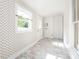 Hallway features patterned wallpaper, tile floors, and a window with natural light at 110 College St, Marshville, NC 28103