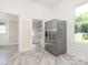 Kitchen area showing stainless steel refrigerator, marble tile floors, and walk-in pantry at 110 College St, Marshville, NC 28103