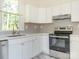 Bright kitchen featuring white cabinets, stainless steel appliances, and a window view at 110 College St, Marshville, NC 28103