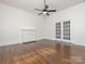 Bright living room with hardwood floors, a decorative fireplace, and French doors to another room at 110 College St, Marshville, NC 28103