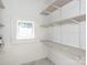 Walk-in pantry features bright shelving and window at 110 College St, Marshville, NC 28103