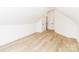 View of the spacious attic, showcasing the wood-look floors and access to the doorway at 135 Brookview Dr, Shelby, NC 28152