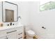 Modern half-bathroom featuring sleek fixtures and ample natural light from the window at 135 Brookview Dr, Shelby, NC 28152