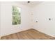 This bright bedroom offers wood-look floors and a view of the outdoors at 135 Brookview Dr, Shelby, NC 28152
