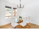 Bright dining room featuring hardwood floors, a modern chandelier, and a glass-top table with six chairs at 135 Brookview Dr, Shelby, NC 28152